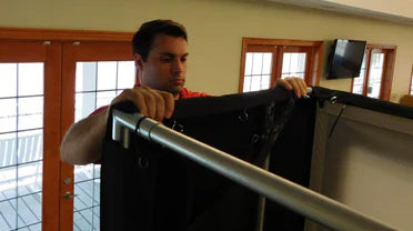 golf simulator setup man standing setting up sides