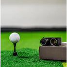 best cameras for golf swing analysis two balls on top of box next to ball on tee