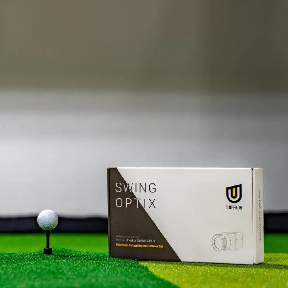 uneekor swing optix cameras box shot on top of hitting mat next to tee with ball