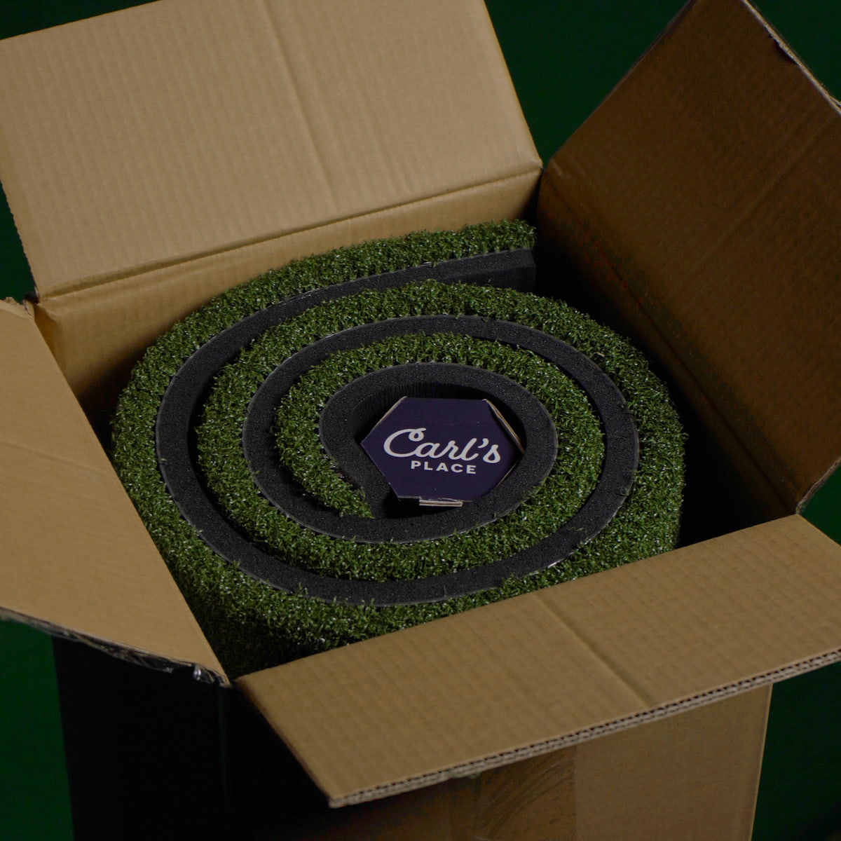 golf simulator mat rolled in box closeup